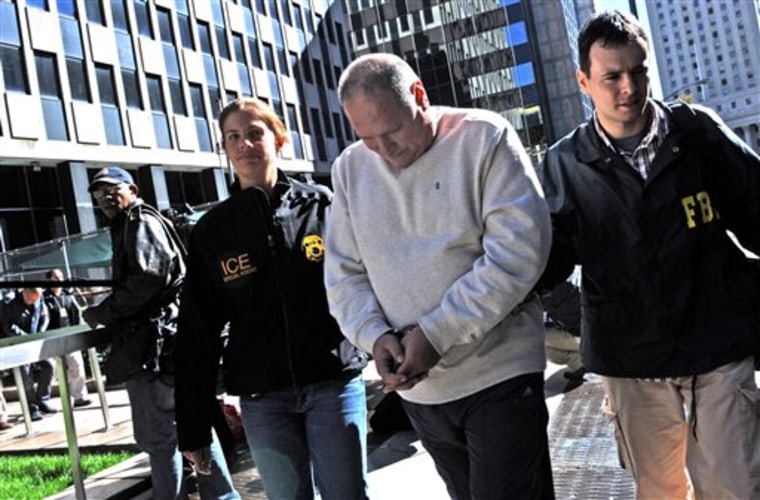 Michael Dobrushin is led in handcuffs from FBI headquarters in New York. Dobrushin is one of 73 people across the country charged by federal prosecutors in a scheme to cheat Medicare out of $163 million, the largest fraud by one criminal enterprise in the program's history, U.S. authorities said.
